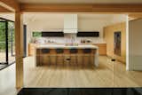 Plum Projects used Bedrosians Magnifica Luxe polished white porcelain for the island, countertops, and backsplash. 