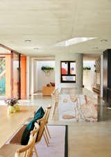 The public wing of the house has a large, open plan that includes the living room, kitchen, and dining room. The six-seater island is made from South African granite sourced through a local quarry. The homeowners had it leathered to look like it came straight out of the ground.