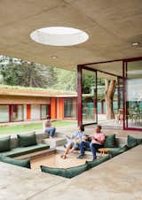 The home's central courtyard provides green space, as well as a place for the two boys, Jesse and Jamie, to play. The use of bright colors for transitional elements—windows and doors—brightens the otherwise neutral palette.