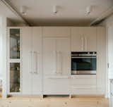 Custom MDF cabinetry was built by local cabinetmakers InGrain Custom Millwork and painted a soft gray shade.