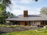 According to the homeowners, one concession they made to save money was downgrading the exterior retaining wall from a gabion retaining wall to native limestone blocks.