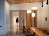 Joan has always admired midcentury design and architecture, so Signal added a slatted fir divider between the dining room and the guest wing, giving nod to the iconic era without straying from the home’s contemporary, Northwest appeal. A trio of George Nelson Bubble lamps follows the aesthetic lead.