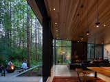 Joan’s main request, aside from a single-level residence, was that she would feel like she was “outside in and inside out” at all times. A sliding glass wall system along the back of the house lets her and Ken open their dining room up to the surrounding forest.