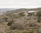 The house sits on a parcel of land near Lake Buchanan. An integrated rainwater collection system in the roof harvests 2,510 gallons per inch of rain—a nearby 29,175-gallon tank is the property's sole water source. 