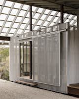 A barn-style door in the carport slides open to reveal the potting room foyer. 