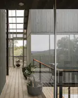 In the foyer, the homeowners are trying their hands at growing native plants. Chris built the upstairs deck, working with stained cedar. "That was a pretty intensive month or so," he says of the project. 