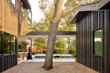 A covered walkway connects the main house (at left) with a flexible-use ADU. The smaller structure was initially offered to Bhavani's parents, but they opted to live under the same roof as the rest of the family. 