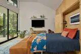 In the ADU, extra natural light comes courtesy of a set of horizontal windows above the large sliding glass entry door. A built-in birch closet hides a fold-down bed when the family doesn't have guests. 