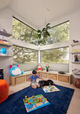Bhavani describes the boys' playroom as "another periscope moment." Perched at the northwest corner of the house, it looks over the backyard, framing a large oak tree in two sets of stacked windows.   