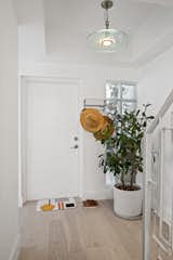 The Hallway is welcoming with a fresh paint of gray on the entry stairway