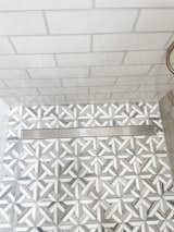 Geometric shower pan tile with linear drain