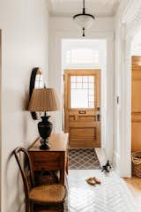 Living Room, Ceramic Tile Floor, Table Lighting, and Console Tables The original 130 year old door that I had restored!  Photo 8 of 18 in Old to Almost New by Pamela Bowles