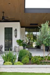 Outdoor, Garden, Walkways, Vertical Fences, Wall, Stone Fences, Wall, Planters Patio, Porch, Deck, Hanging Lighting, Wood Patio, Porch, Deck, Shrubs, Wood Fences, Wall, Gardens, Side Yard, Tile Patio, Porch, Deck, Hardscapes, Stone Patio, Porch, Deck, Trees, Grass, and Metal Fences, Wall Courtyard Garden  Photo 1 of 26 in Beverly Lane by Reagan & André Architecture Studio