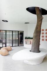 Outdoor, Concrete Patio, Porch, Deck, Stone Patio, Porch, Deck, Side Yard, Concrete Fences, Wall, and Hardscapes Courtyard, Skylights in the ceiling following the seating elements in the space   Photo 12 of 22 in Fluid Rhapsody by Studio Dashline
