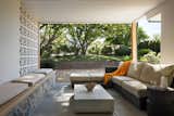 The semi-private outdoor lounge connects directly to the interior living room allowing the party to flow outside. The breeze-block wall mediates the public and private areas.