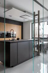 Kitchen, Refrigerator, Wood Cabinet, Microwave, Accent Lighting, Wood Backsplashe, Dishwasher, Floor Lighting, and Cooktops  Photo 8 of 32 in RE APARTMENT by ZROBIM architects