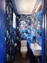 The whimsical jewel box powder room is a delightful surprise.