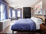 The main bedroom exudes sophistication with its clean lines and cool toned colors. 
