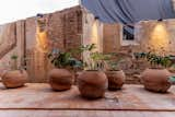 Adobe wall preserved from the original house at the site that blend in with the Puebla clay floors and pots.