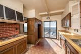 Before: narrow kitchen with a patio door to a beautiful balcony