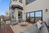 After: renovated deck with large bi-folding door and railing color to match the trims