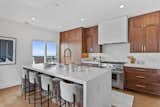 After: The kitchen was opened up to accommodate a large island and create multifuctional spaces with flow