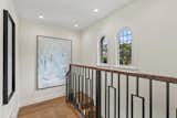 After: Walls were removed from the original confined central stairway, making it an open stair, allowing it to become an art gallery.