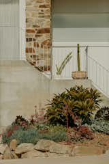 The new steel balustrade echoes the steel staircase inside while the white painted brick finish is a nod to the home's original facade. 