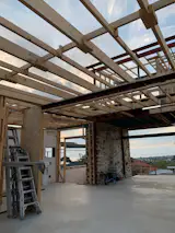 Before: Little remained of the home's original interior other than the stone wall and double brick shell. The concrete slab was a practical choice for flooring and works with the natural tones of the stone.