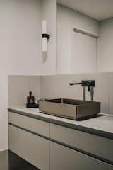 The sleek and simple bathroom taps into Carmen's love of industrial design.