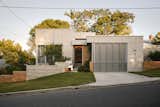 Exterior, Tile Roof Material, Brick Siding Material, Concrete Siding Material, Wood Siding Material, and House Building Type  Photo 20 of 103 in Houses and spaces by Jacqueline Metz from Before & After: She Cloaked Her 1970s Brick Home in a Concrete-and-Metal “Skin”