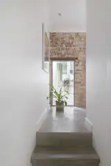 The decorative arch and timber lintel were hidden beneath a thick render that had to be carefully prised off. "The more we pulled off, the more the bricks fell out!