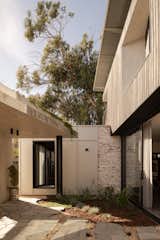 The C-shaped house protects the alfresco area from the cold winter winds.  Photo 4 of 20 in A Bunker-Esque Home in Western Australia Is a Fortress Against Whipping Winds