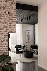 The living room, with its charred timber ceiling and cozy fireplace, is Lachie's favorite space in the house.