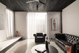 The living room, with its charred timber ceiling and view of the courtyard, is Lachie's favorite space in the house.