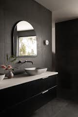 Plenty of natural light ensures the dark bathrooms don't feel gloomy.