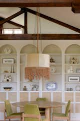 Isaza-Smith suggested painting the pressed metal detail in the rafters in order to better showcase the century-old hoop pine beams. The pendant light is a custom design by Lana Launay, while the shelving is a simple IKEA bookcase hack.