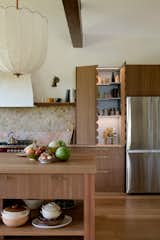 With plenty of storage and pretty details like the scalloped pantry doors and oversized pendant light by Lana Launay, the new kitchen blends practicality with whimsy.