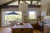 Now the kitchen feels generous and connected to the beautiful landscape outside with a big picture window over the sink and large bifold doors.