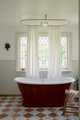A freestanding tub is now the star of the bathroom. The shower curtain rail above was custom made for the room.