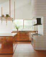 The grout in the tiling around the oven and Juliet balcony above was matched to blend with the terra-cotta tiling and copper finishes.