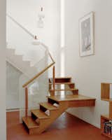 A custom metal mesh balustrade wraps around the staircase to give it the spiral feel the owners were looking for. The timber was resurfaced to get it looking good as new.