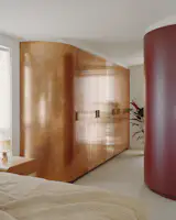 To save on costs, Caught suggested pulling back to just one copper-clad wardrobe in the primary bedroom. The rich burgundy on the opposite robe is the perfect foil.