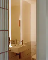 The new powder room is a sleek and simple design that reflects the home’s minimalist approach.