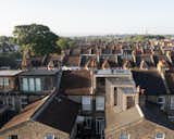 A Brick and Glass Extension Telescopes Out Across the Roof of a London Home - Photo 1 of 10 - 