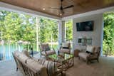 Upper-level covered porch fireside seating.