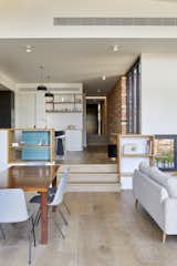 Dining Room, Shelves, Light Hardwood Floor, Table, Bar, Pendant Lighting, Ceiling Lighting, and Bench  Photo 6 of 15 in Glen Iris House by Jost Architects