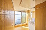 Bath Room, Ceramic Tile Floor, Ceiling Lighting, Ceramic Tile Wall, Open Shower, Drop In Sink, and One Piece Toilet  Photo 7 of 18 in Solar + Design = Tiny Home on the Water by Crossboundaries