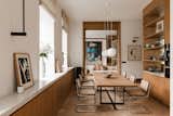 Dining Room, Table, Chair, Wall Lighting, Shelves, Lamps, Storage, Medium Hardwood Floor, and Pendant Lighting  Photo 1 of 21 in Pre-War Building in Warsaw by Magdalena Romanowska