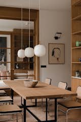 Dining Room, Pendant Lighting, Chair, Lamps, Medium Hardwood Floor, and Table  Photo 2 of 21 in Pre-War Building in Warsaw by Magdalena Romanowska